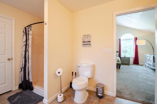 a bathroom with a toilet and a walk in shower at Huge villa in the hearth of Poconos near all. in Long Pond
