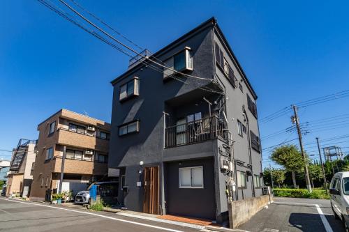 a black building on the side of a street at 84-2, Shiomi 102, Entire room for rent, 潮見B102 in Tokyo