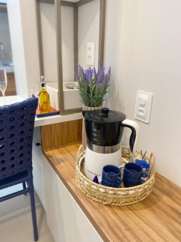 a coffee maker in a basket on a counter at Sunny Hall - Porto de Galinhas in Porto De Galinhas