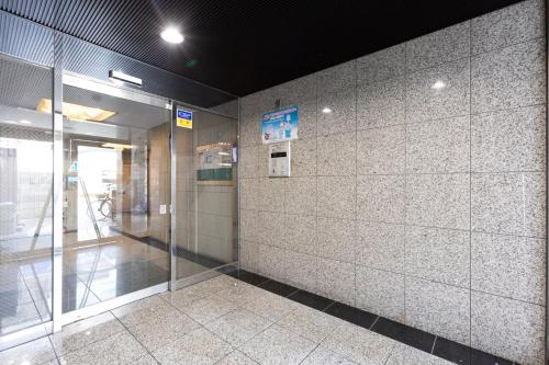 an empty lobby of a building with a glass door at Albion City Osaka Tennoji in Osaka
