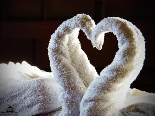 two white towels with a heart on top at Majestad Hotel Boutique in Arequipa