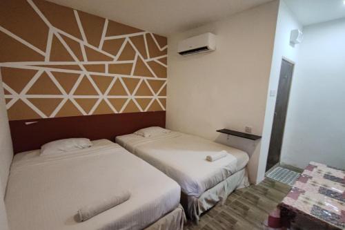 Ένα ή περισσότερα κρεβάτια σε δωμάτιο στο Maleeq Hotel Meru Ipoh