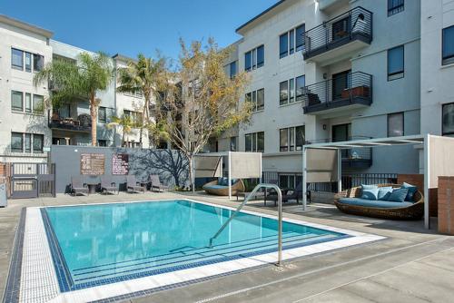 a swimming pool in front of a apartment building at Luxury One Bedroom minutes from The Grove in Los Angeles