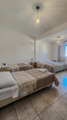 a bedroom with three beds in a room at Cajón de Agua in Cafayate
