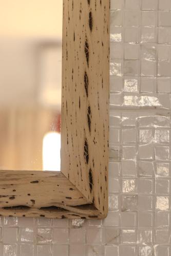 a close up of a wooden mirror on a wall at Cajón de Agua in Cafayate