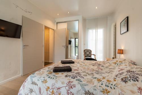 a bedroom with a large bed and a television at Villa de Charme Climatisée avec Piscine au Centre in Gardanne