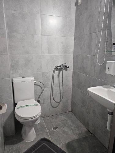 a bathroom with a toilet and a sink at Nisaki Hotel & Elite Suites in Ermoupoli