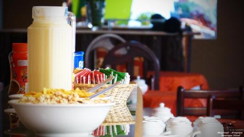 a table with a plate of food and a bottle of orange juice at Majestad Hotel Boutique in Arequipa