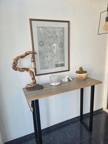 a table with a picture and a snake on it at Nisaki Hotel & Elite Suites in Ermoupoli