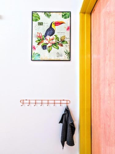 a picture of a bird hanging on a wall at Private Room with Bathroom in Kuala Lumpur