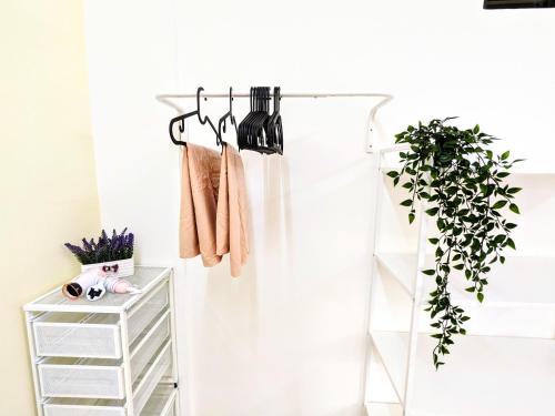 a white closet with hangers and a shelf at Private Room with Bathroom in Kuala Lumpur