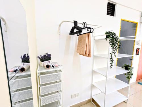 a walk in closet with white shelving at Private Room with Bathroom in Kuala Lumpur