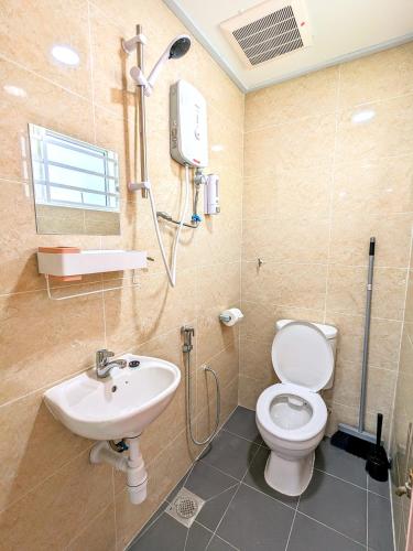a bathroom with a white toilet and a sink at Private Room with Bathroom in Kuala Lumpur