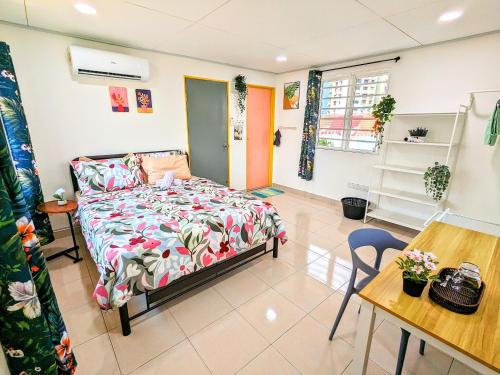a bedroom with a bed and a table and a desk at Private Room with Bathroom in Kuala Lumpur