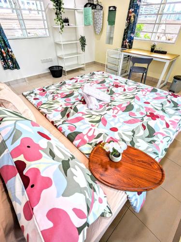 a large bed with a wooden table on top of it at Private Room with Bathroom in Kuala Lumpur