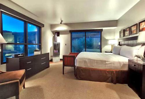 a bedroom with a large bed and a large window at Main & SKY by EXMAR in Park City