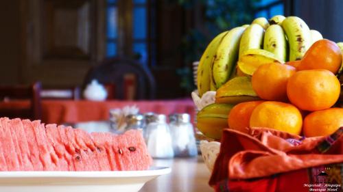a table with a bunch of bananas and oranges at Majestad Hotel Boutique in Arequipa