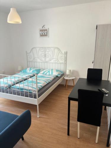 a bedroom with a bed and a table and a desk at Apartment Vlado in Sukošan