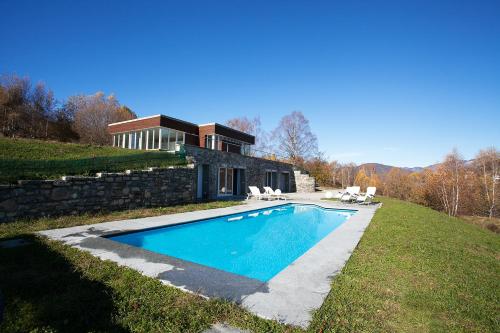 a house on a hill with a swimming pool at Villa La Betulla in Cerano d'Intelvi