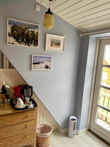a room with a staircase with a dresser and a window at Faaborg Bed and Breakfast in Fåborg