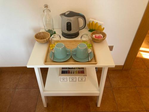 a small table with a tea kettle and cups on it at La Tonaccia - B&B per due in Orta San Giulio
