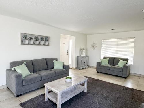 a living room with two couches and a coffee table at Modern Resort Condo - Pools, Courts & Scenic Views in St. George