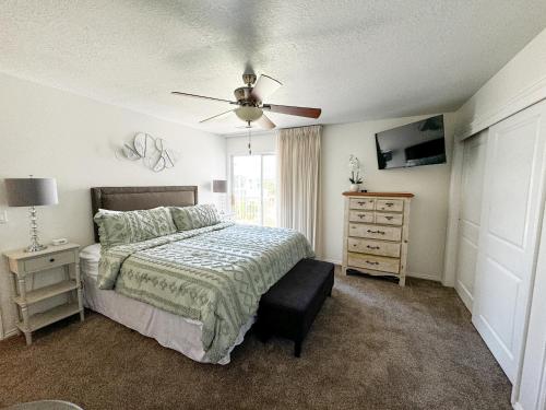 a bedroom with a bed and a ceiling fan at Modern Resort Condo - Pools, Courts & Scenic Views in St. George