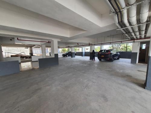 a large parking lot with a car parked in it at Green Mount View Two Bed Room Apartment in Nuwara Eliya