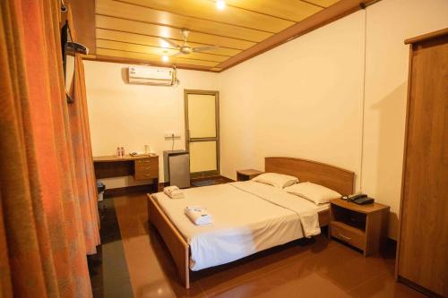 a bedroom with a bed and a sink and a mirror at GP Hotels and Resorts in Nashik