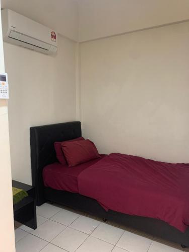 a bedroom with a bed with red sheets and a heater at Akar Hotel Kampung Baru in Kuala Lumpur