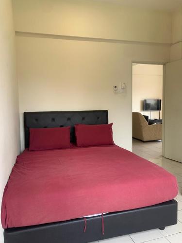 a large bed with red pillows in a bedroom at Akar Hotel Kampung Baru in Kuala Lumpur