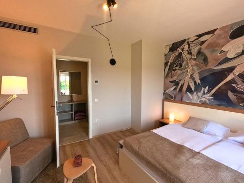 a small bedroom with a bed and a couch at Villa Badi in Umag