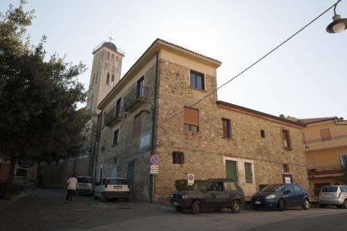 a large brick building with cars parked in front of it at Casa Lippi in Casal Velino