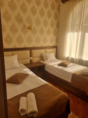 a room with two beds and a window at Jermuk Moscow Health Resort in Jermuk