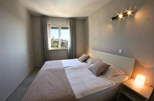 a bedroom with a large bed and a window at Villa Badi in Umag