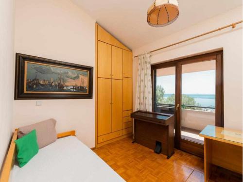 a bedroom with a bed and a desk and a window at Thea in Kavala