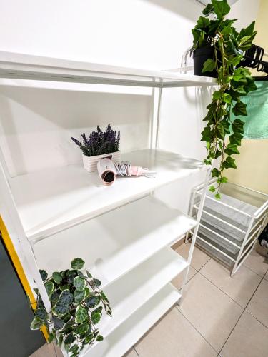 a white refrigerator with potted plants on it at Private Room with Bathroom in Kuala Lumpur