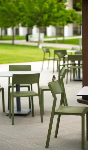 a group of green chairs and tables in a park at Rixos Water World Aktau - Theme Park Free Access in Aktau
