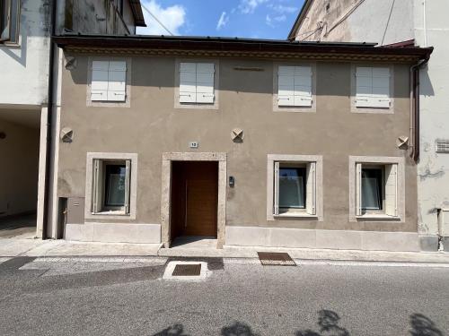 a building with a door and windows on a street at Follinetta10 - enjoy holiday home in the Prosecco hills in Follina