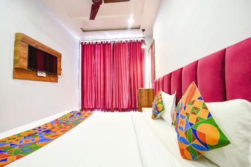 a room with a bed and a red curtain at FabExpress 56 Amritsar in Amritsar