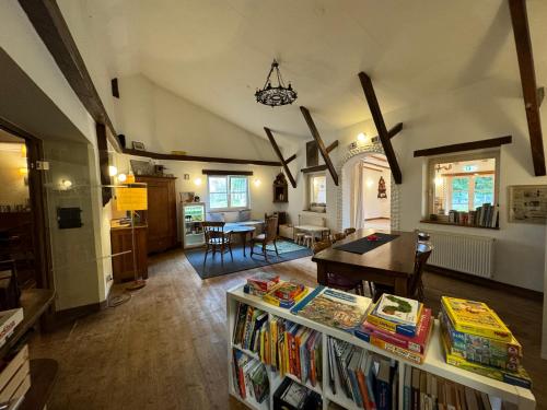 a living room with a table with books on it at Hinkelshof - als Ferienwohnung - Selbstversorgerküche & Aufenthaltsräume - Südeifel, Mullerthal, Vianden in Körperich