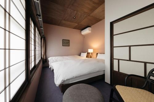 a hotel room with a bed and a window at ZOPA Nishicho in Kanazawa