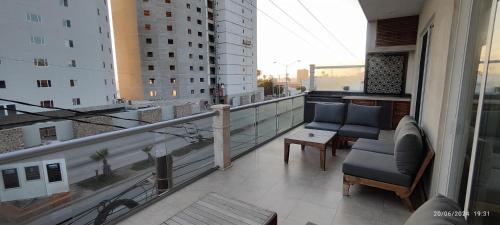 a balcony with two chairs and a table on a building at Rosarito Beach condominio in Rosarito