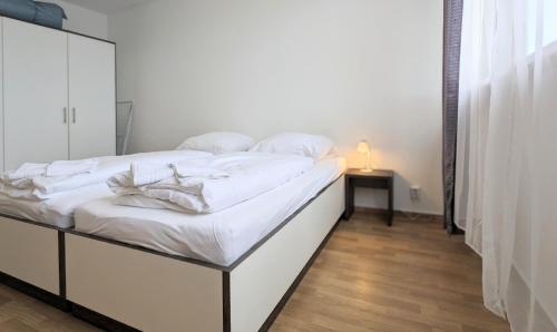 a bedroom with two beds and a mirror at GWG City Apartments III in Halle-Neustadt
