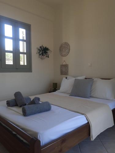 two twin beds in a room with a window at M. Houses 3 in Agios Romanos