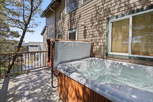 a hot tub on a balcony of a house at Chinook House MCA 1219 - Meredith Lodging in Manzanita