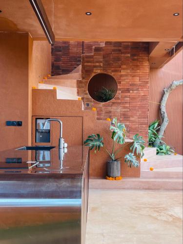 a kitchen with a counter with a sink and a staircase at Kula Terra One Bedroom Villa in Kerobokan