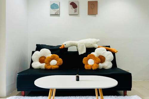 a group of stuffed animals sitting on a couch at Comfy-Concept Apartment @ B.Bintang (3min walk LRT, Lalaport, TimeSquare) in Kuala Lumpur