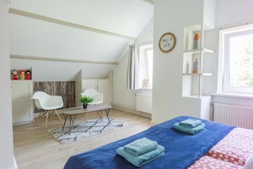 a bedroom with a blue bed and a table at Roggebroek 44 in Stavoren
