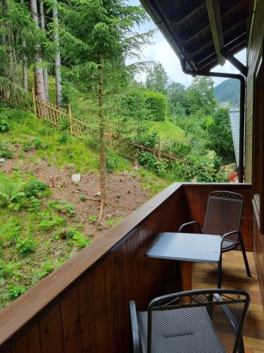 a table and two chairs on a balcony with a view at The Lodge at Bad Gastein in Bad Gastein